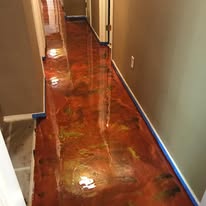 Metallic epoxy floor coating in a marbled red and gold finish
