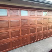 Garage door finished with a faux mahogany wood-grain coating
