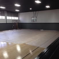Wide view of a finished gym floor coating with dark accent walls