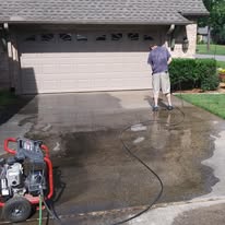 Pressure-washing a driveway before a coating project