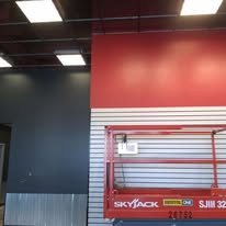Commercial retail space with a finished dark charcoal and red accent wall